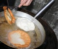 Street vendor while he is cooking the tasty pancakes dipped in b Royalty Free Stock Photo