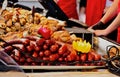 street vendor food display stand. closeup of fried juicy pork sausages. fast food and eating.