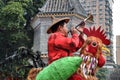 CANTON, CHINA Ã¢â¬â CIRCA DECEMBER 2017: Street vendor in Guangzhou dresses up as a colorful rooster.