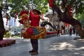 CANTON, CHINA Ã¢â¬â CIRCA FEBRUARY 2018: Street vendor in Guangzhou dressed up as a colorful rooster who blows into a horn