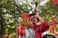 CANTON, CHINA Ã¢â¬â CIRCA JANUARY 2017: Street vendor in Guangzhou dressed up as a colorful rooster who blows into a horn