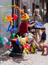 Street vendor of inflatable balls makes for a boy a crown of ball in Tel Aviv city in Israel