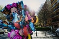 Street vendor with many children`s inflatable balloons with cartoon shapes