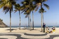 Street vendor pausing for refreshment on Leme beach boulevard