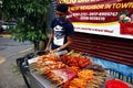 Street vendor sell assorted grilled pork and chicken innards barbecue at his makeshift food stall Royalty Free Stock Photo