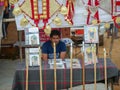 A street vendor selling bamboo sticks and horse decoration items on stall