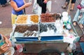 A street vendor sells fried cockroaches, scorpions and other insects