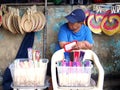 A street vendor sells a variety of colorful hand fans
