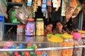 Street vendor sits in her small shop