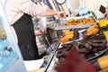 Street vendor stand Fried dough, traditional Spanish breakfast churros bathed in chocolate Royalty Free Stock Photo