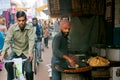 Street vendor of traditional cake bread and cyclist