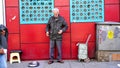 A street vendor who earns money with weighing out people