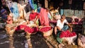 Street vendors selling colorful roses and flowers in baskets in the ancient Mullick
