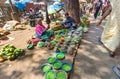 Street vendors selling green peas and other vegetables from ground