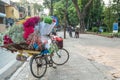 Street vendors selling various types of flowers from their bicycle in Hanoi Old Quarter.