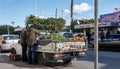 Street vendors of vegetables, beans, fruit and oranges from a battered old Japanese pickup truck on the side of the road