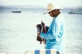 Street vendors walk on the sand of Porto da Barra beach