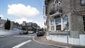 Street view of a beautiful european city with many cars parked along the road. Action. Beautiful hotel, brick building Royalty Free Stock Photo