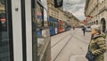 Street view of Bern. Red tram goes on the street near walking people