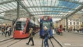 Street view of Bern. Red tram goes on the street near walking people