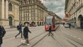 Street view of Bern. Red tram goes on the street near walking people