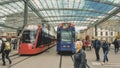 Street view of Bern. Red tram goes on the street near walking people