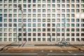 Street view with a bike locked by a street nameplate and a street lamp, with modern designed building background