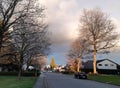 Street view of Canadian Vancouver neighbourhood. Cherry trees blossom. Beautiful sky