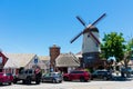 Street view of cars parked along Alisal Road and The Round Towerand and Windmill in background. - Solvang, California, USA - June Royalty Free Stock Photo