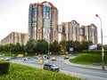 Street view, the cars on the road and greenery and in the background Kuntsevo residential complex