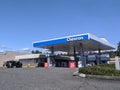 Street view of a Chevron fuel pump station on a sunny day