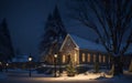 a street view on christmas night with church and house lighted up and a tree is near a building with lit lights Royalty Free Stock Photo