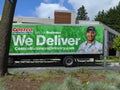 Street view of a Costco Business delivery truck parked on the side of the road downtown