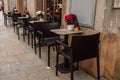 Cozy street cafe with black chairs and potted flowers on the table during the morning. Krakow, Poland, Europe Royalty Free Stock Photo