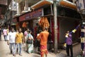 street view with devotees, vendor shops for spiritual offering items and priests