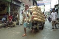 Street view of Dhaka with porter lugging cement