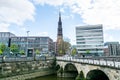 Street view of downtown with beautiful building with clock tower of St. Catherine`s Church and bridge at the bank of Nikolaifleet