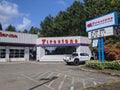 Street view of a Firestone Complete Auto Care Center on a sunny day Royalty Free Stock Photo