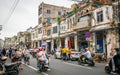 Street view of Haikou old town with ancient decrepit buildings and crowded Boai north road with people and scooters in Qilou Royalty Free Stock Photo