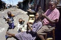 Street view of hairdresser and customer in slum Royalty Free Stock Photo