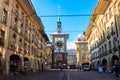 Street view of Kramgasse with fountain and clock tower Zytglogge in the historic old medieval city centre of Bern, Switzerland Royalty Free Stock Photo