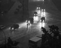 Street view, late evening, heavy rain, umbrella (BW)