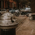 Street view with a motorcycle and cars parked in autumn