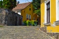 Street view. Narrow upgoing street with yellow houses