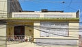 Street view of an old building facade with a tangle of cables in front, Otavalo, Ecuador Royalty Free Stock Photo