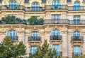 An elegant Parisian building facade in an upscale residential neighborhood.