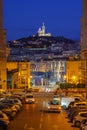 Street view and the old port and basilica of notre dame de la garde at night in Marseille, France Royalty Free Stock Photo