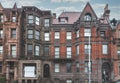 Street view of an old, red brick apartment building in Philadelphia
