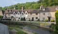 Street view of old riverside cottages in the picturesque Castle Combe Village, Cotswolds, Wiltshire, England - UK Royalty Free Stock Photo