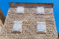 street view of the old town of Budva in Montenegro, medieval European architecture, city streets, windows with wooden shutters, Royalty Free Stock Photo